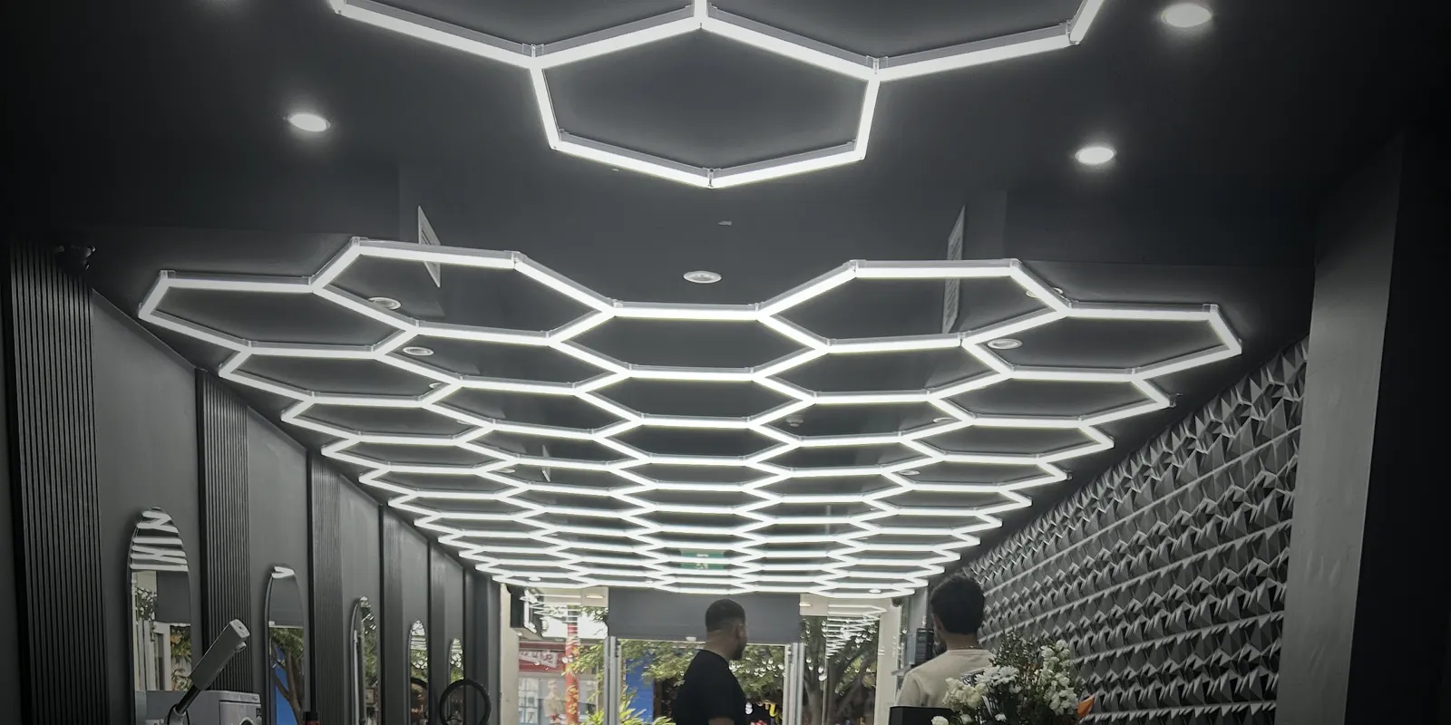 The glowing hexagon ceiling inside BarberXCulture
