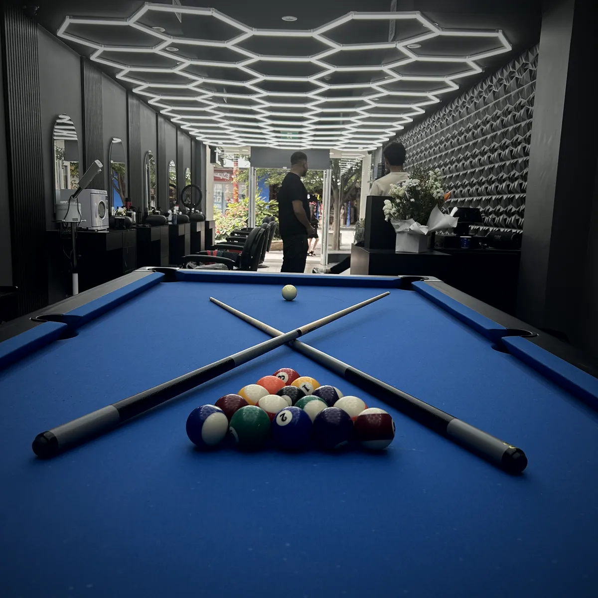 A blue pool table set up in the shop's lounge